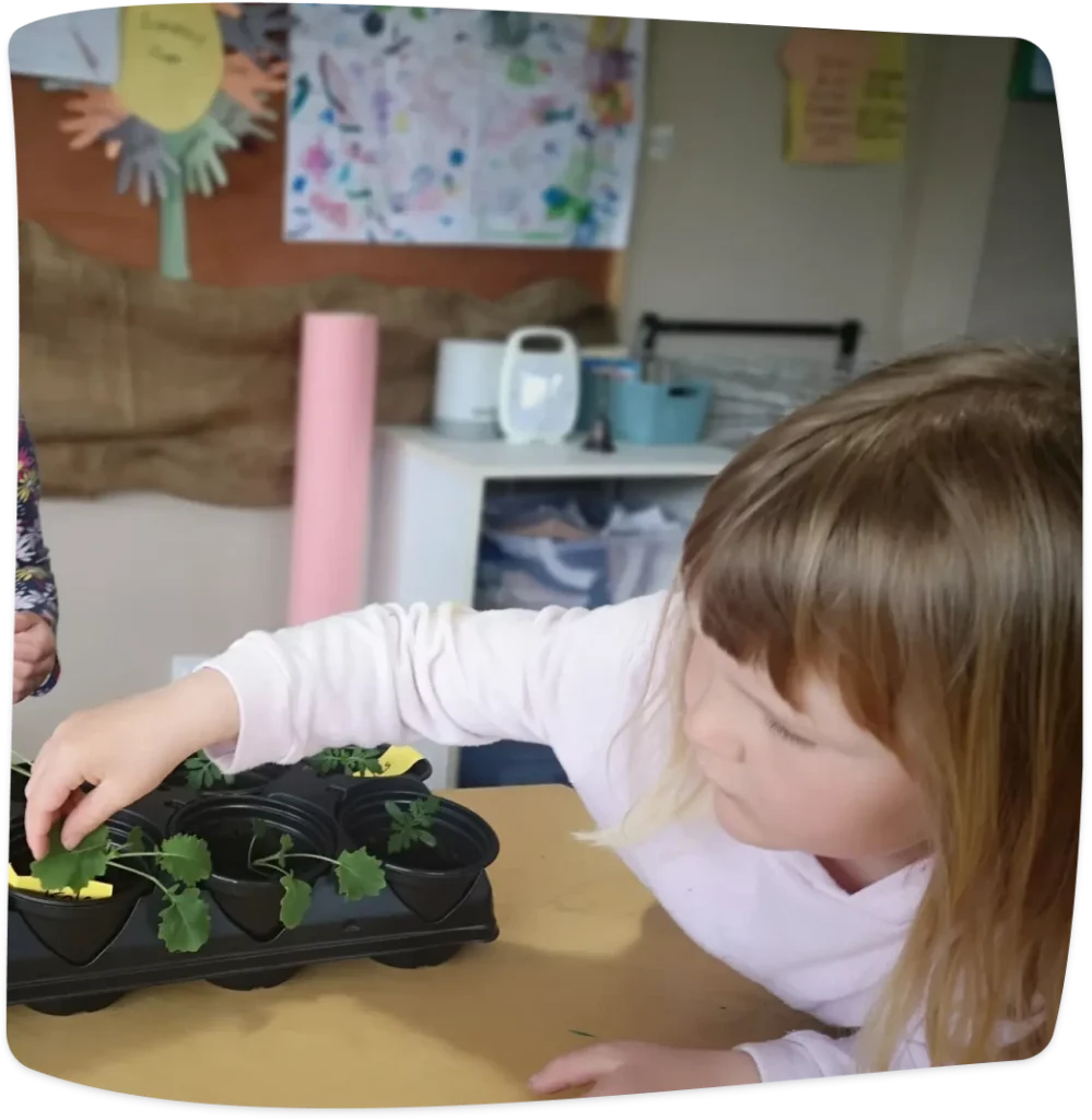 Child playing with growing plant